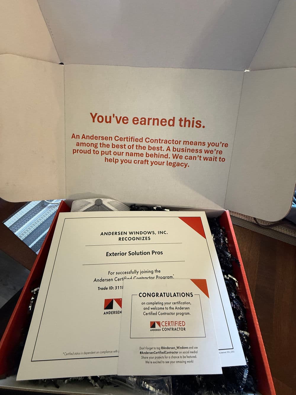 Andersen Certified Contractor recognition certificate in a gift box for Exterior Solution Pros.